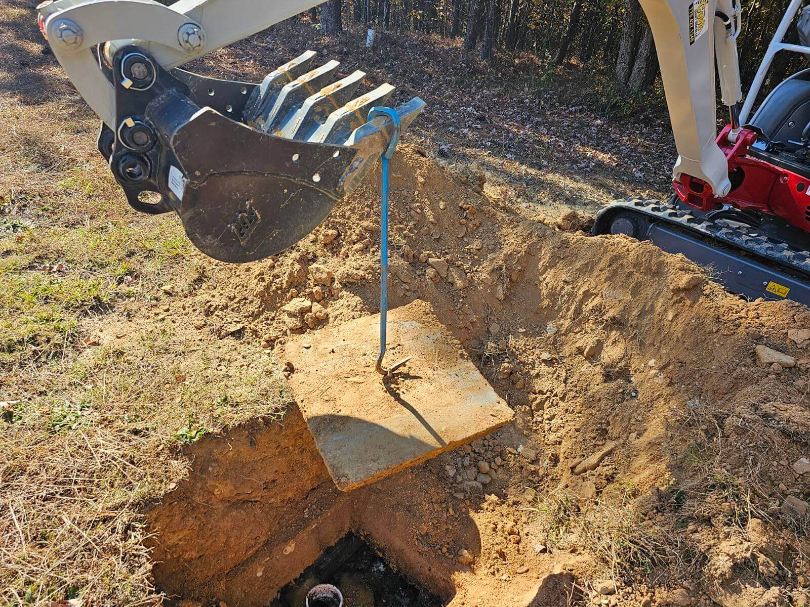 An excavator digging a hole in the ground.