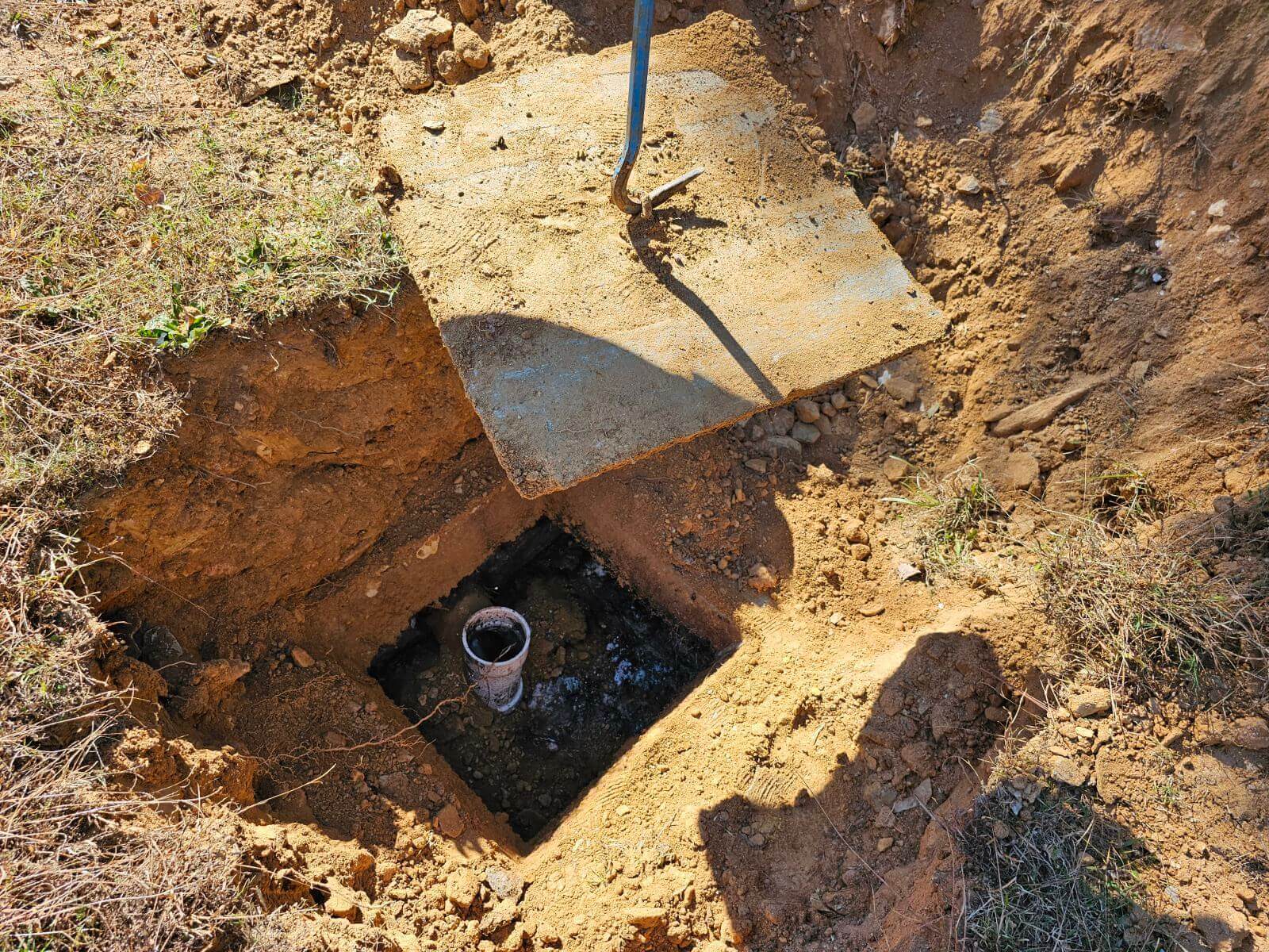 A man is digging a hole in the ground.