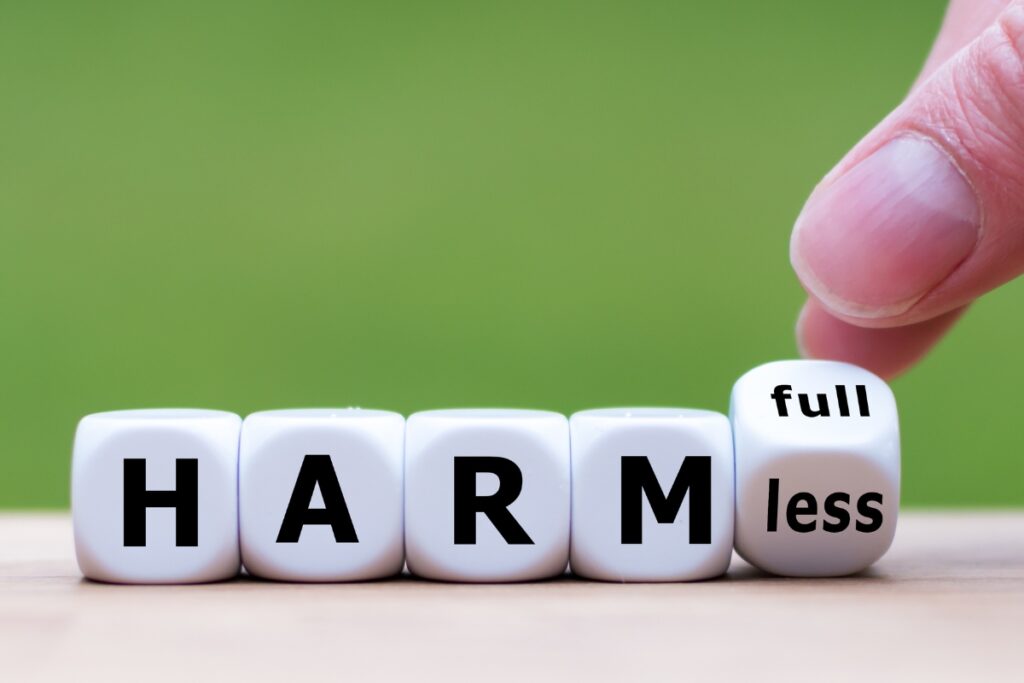 A person engaging in septic tank myths by pushing a piece of wood labeled "harmless".