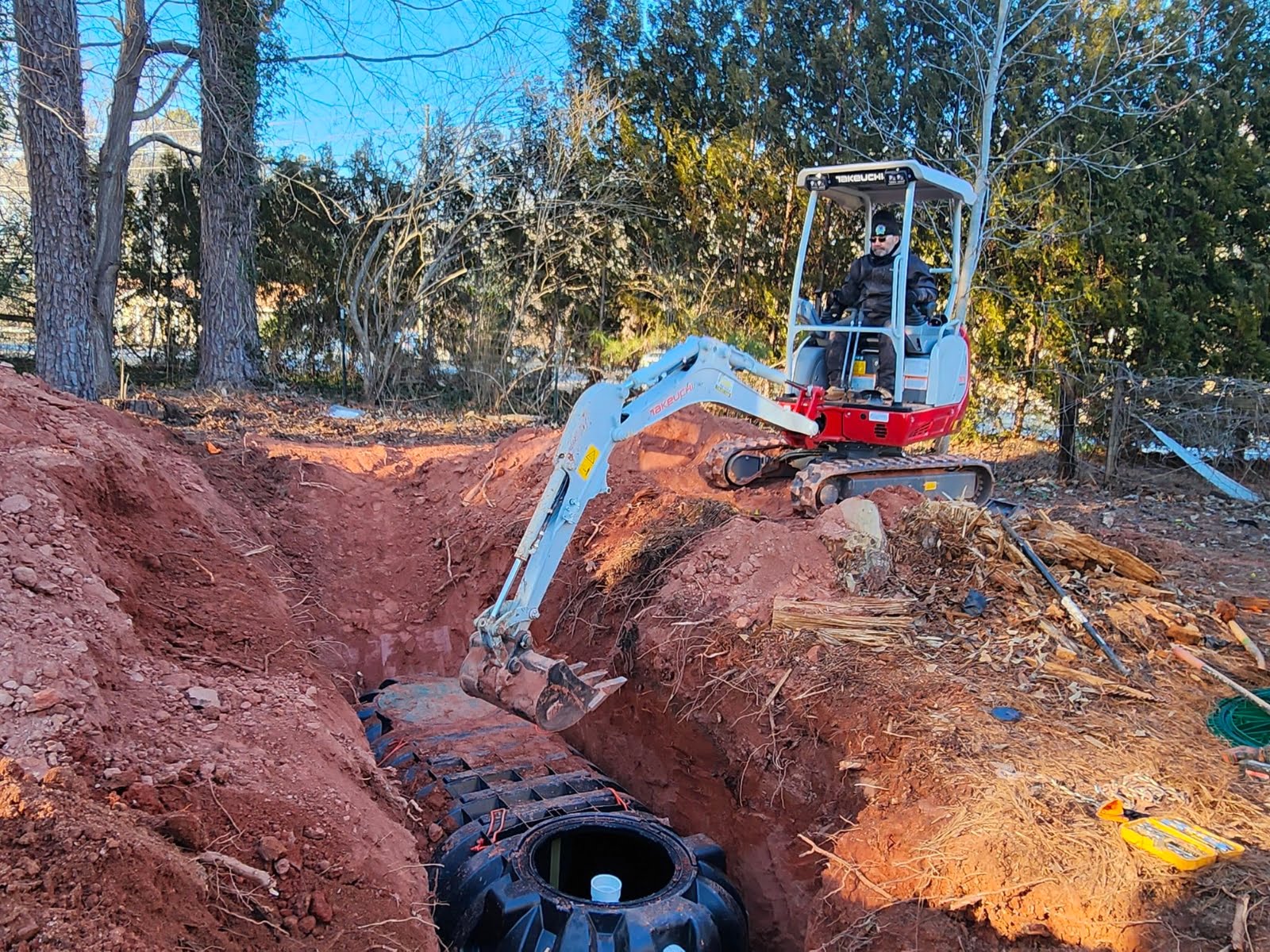 An excavator performing septic tank installation.