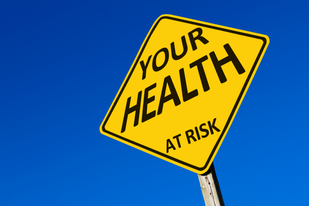 A yellow sign displaying the words "your health at risk."