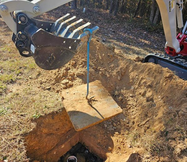 An excavator digging a hole in the ground.
