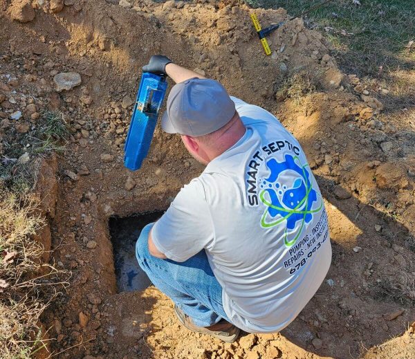 A man working on a hole in the ground.