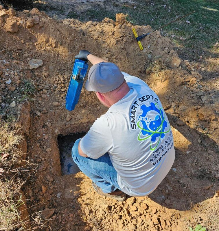 A man working on a hole in the ground.
