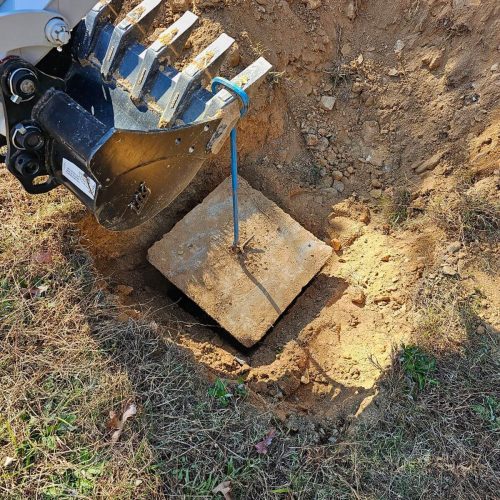 An excavator digging a hole in the ground.