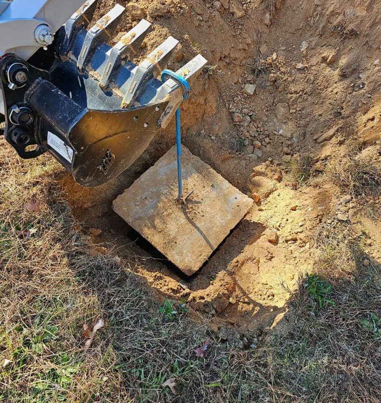 An excavator digging a hole in the ground.